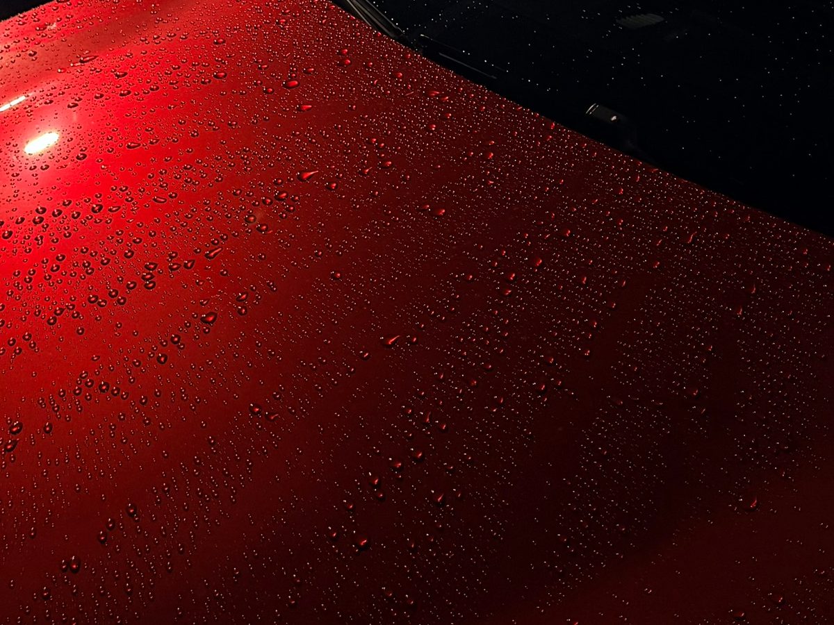 Water beading on glossy red paint