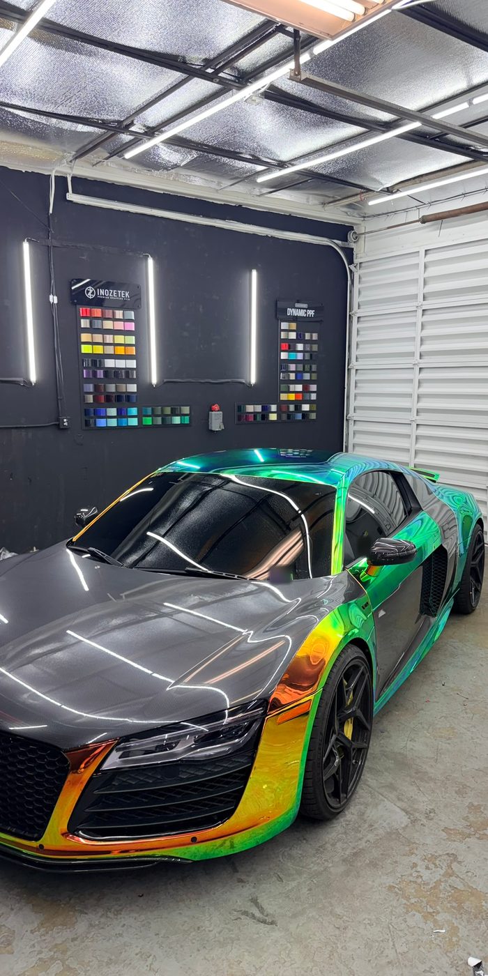 Audi R8 in a holographic color-shift wrap in the bay