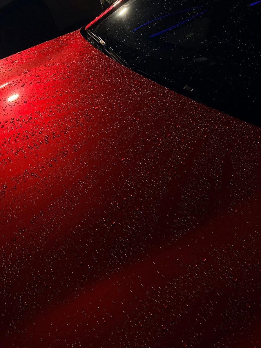 Water beading on glossy red paint