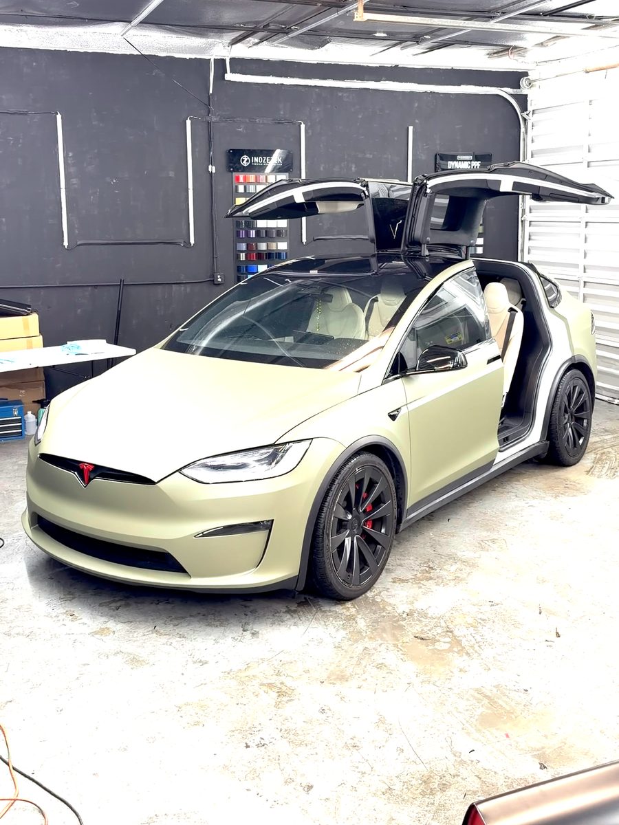 Tesla Model X in a sage green color-change wrap