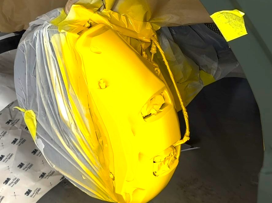 Lamborghini Urus brake caliper freshly painted yellow, rotor masked off