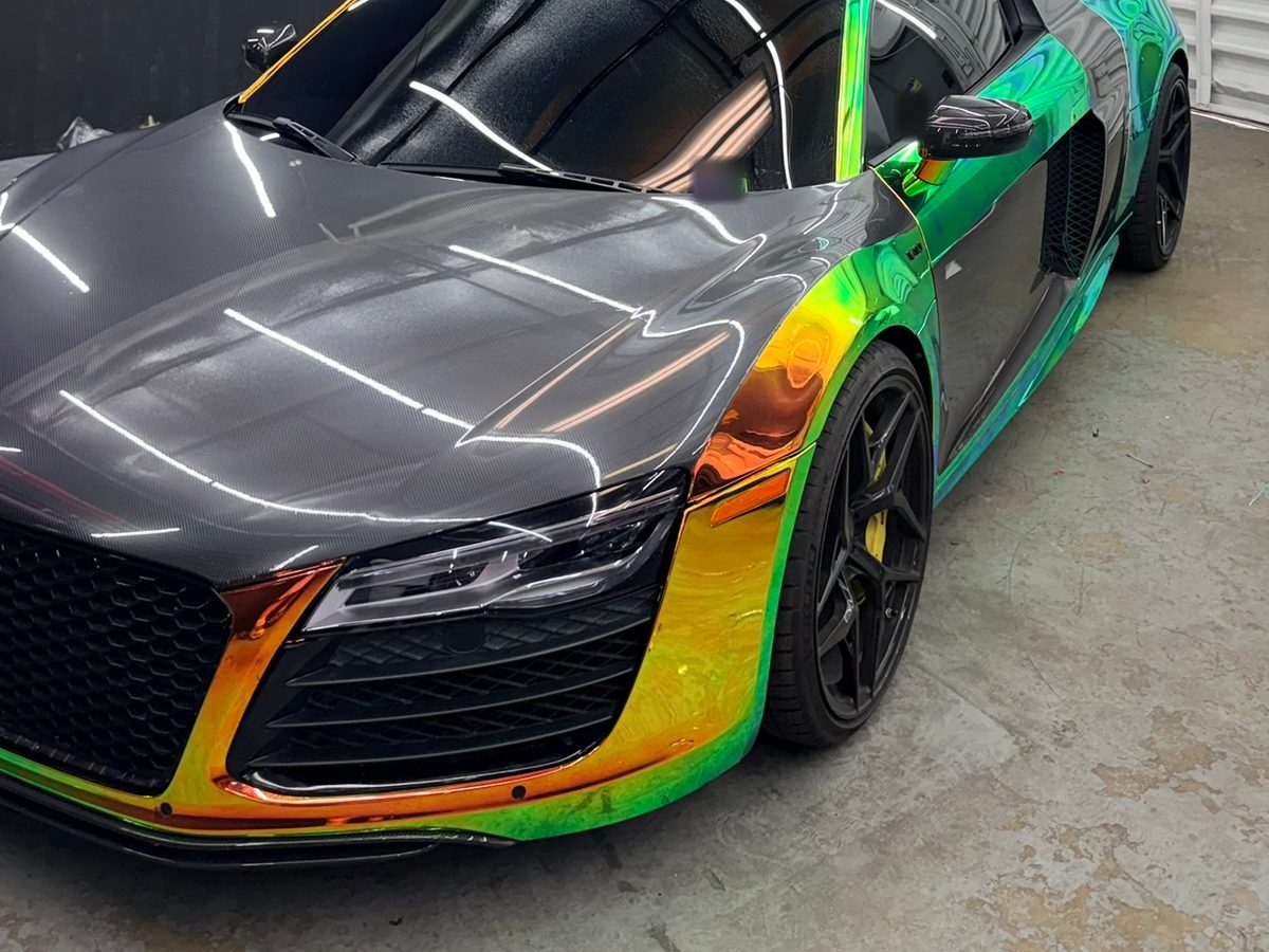 Audi R8 in a holographic color-shift wrap in the Elite Wrap bay
